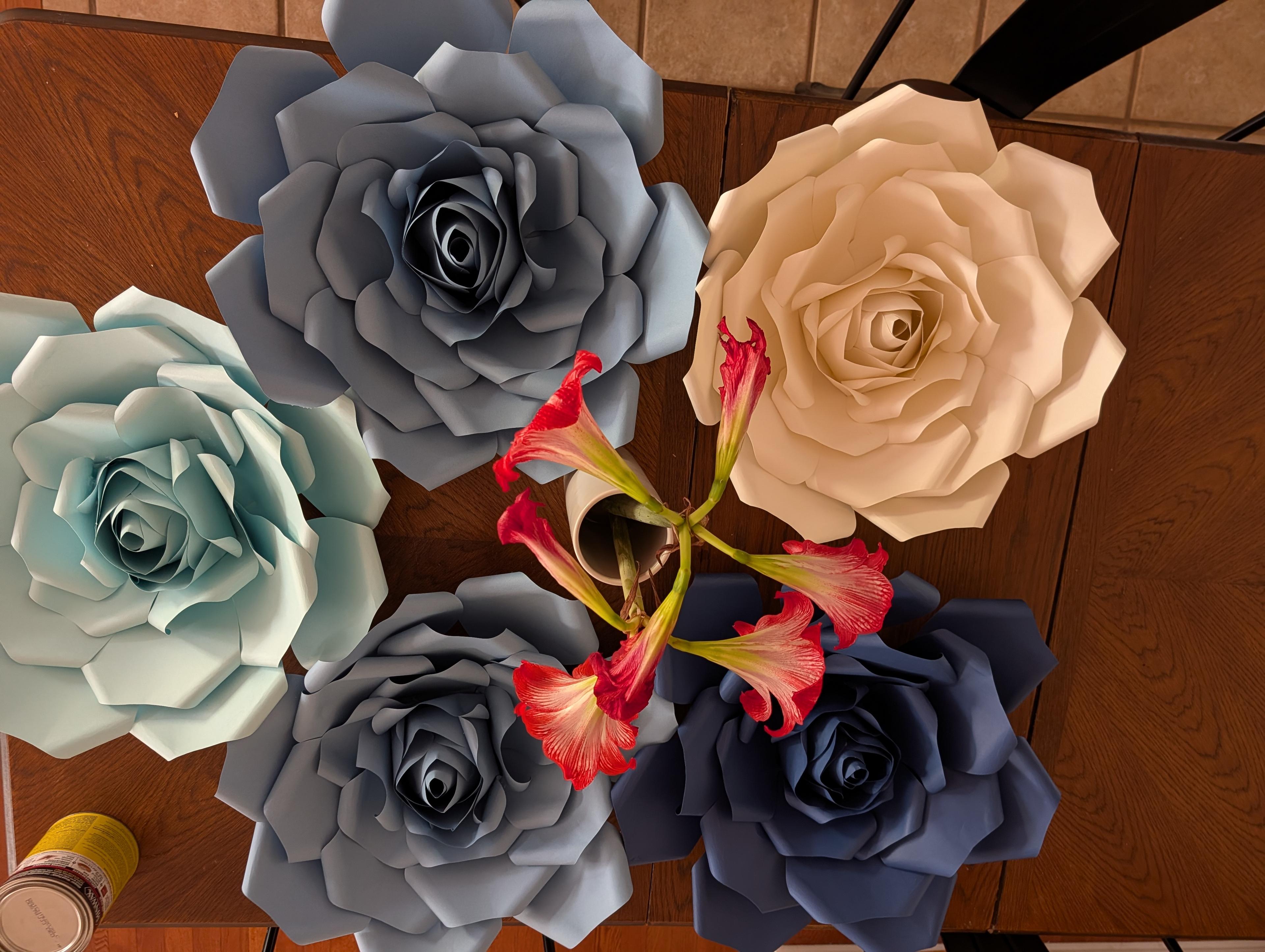 Handcrafted paper roses by Cora in shades of blue, slate, cream, and navy